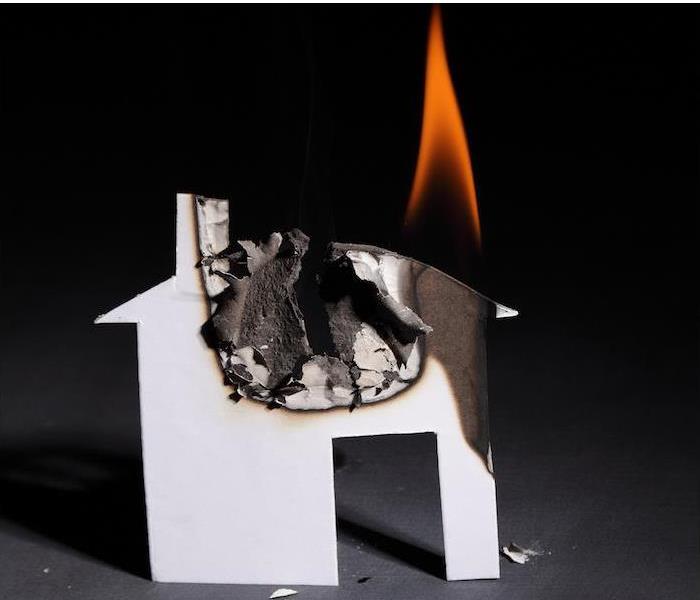 a small paper house burning